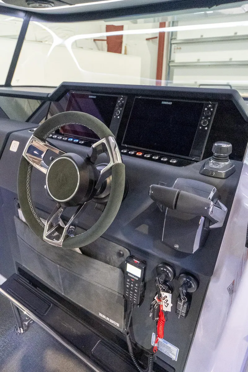 Slide: The Image of 2024 Axopar 37 Cross Cabin XC helm with advanced navigation controls. - 34