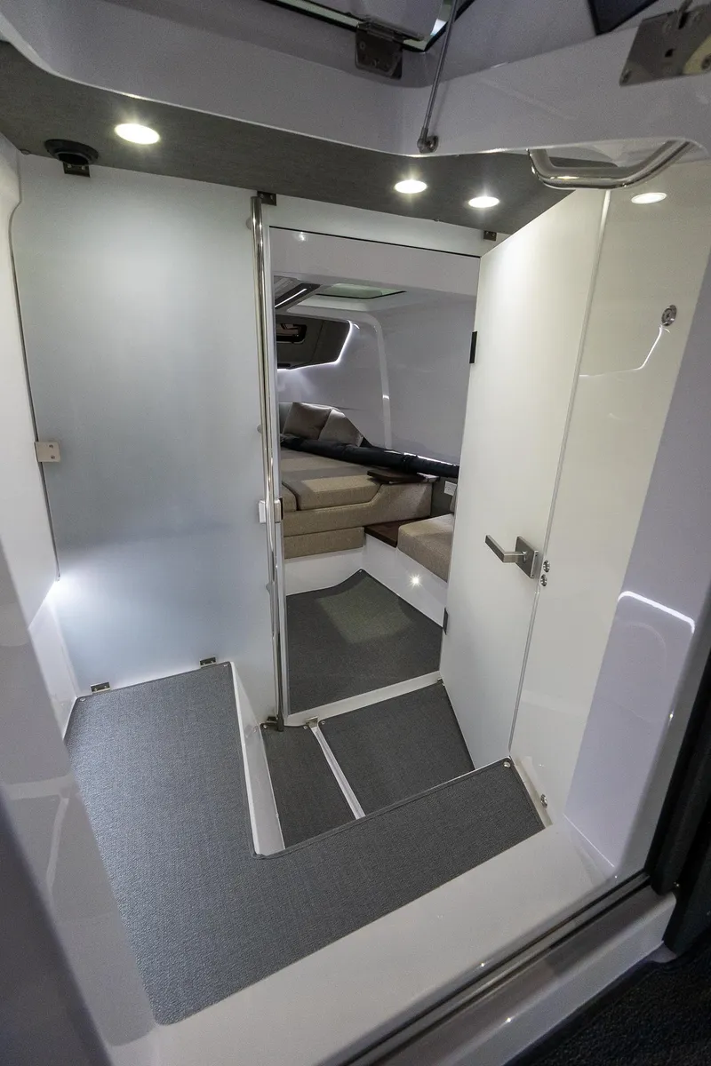 Slide: The Image of Interior of 2024 Axopar 37 Cross Cabin XC, featuring modern design and cozy seating area. - 37