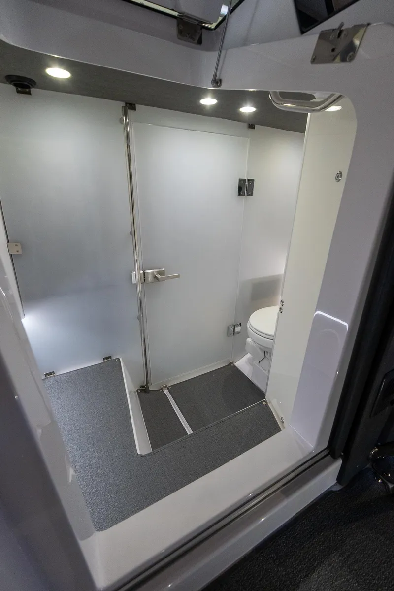 Slide: The Image of 2024 Axopar 37 Cross Cabin XC bathroom with modern design and lighting. - 38