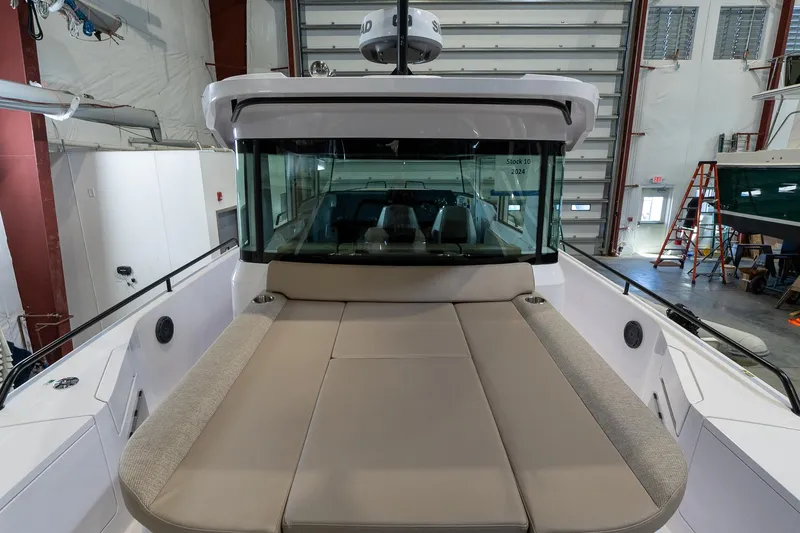 Slide: The Image of 2024 Axopar 37 Cross Cabin XC with front deck lounge in a boatyard. - 4