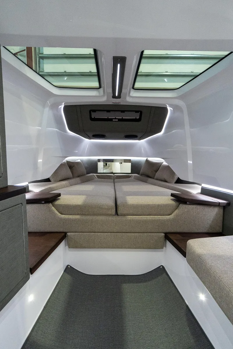 Slide: The Image of 2024 Axopar 37 Cross Cabin XC interior with modern bedding and skylights. - 41