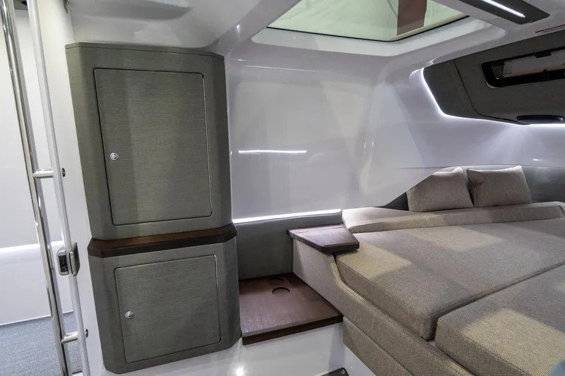 Slide: The Image of 2024 Axopar 37 Cross Cabin XC interior cabin with bed and storage cabinets. - 42