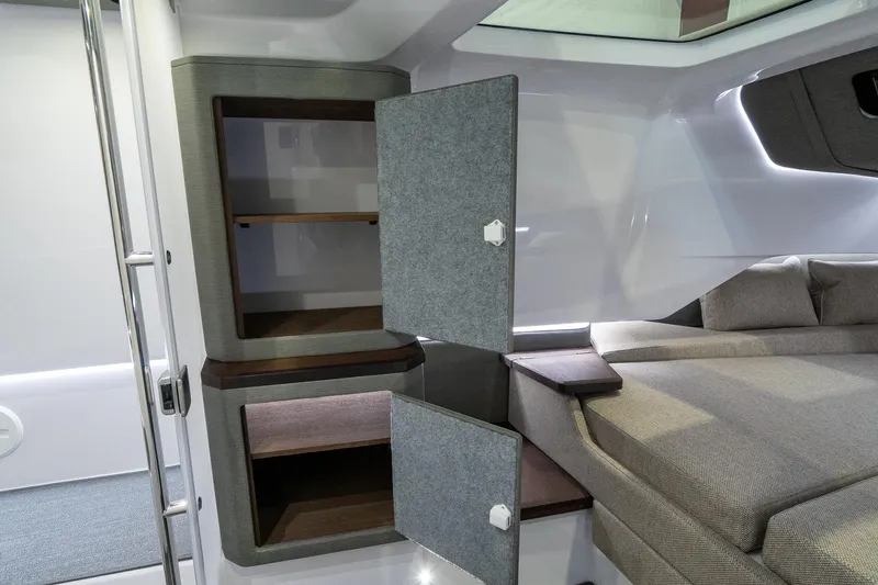 Slide: The Image of Interior cabin of 2024 Axopar 37 Cross Cabin XC with open storage compartments. - 43