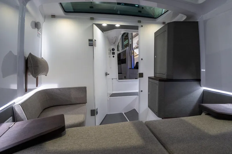 Slide: The Image of Interior of the 2024 Axopar 37 Cross Cabin XC, featuring modern seating and storage. - 44
