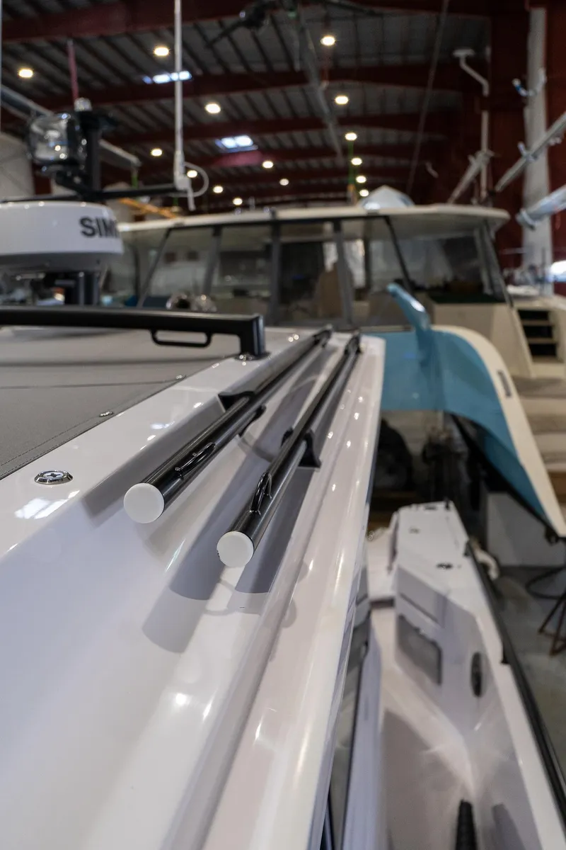 Slide: The Image of 2024 Axopar 37 Cross Cabin XC in a boat showroom. - 45