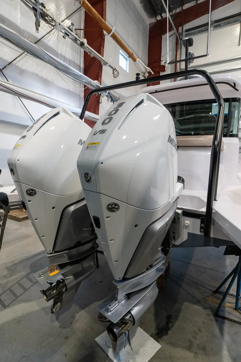 Slide: The Image of 2024 Axopar 37 Cross Cabin XC with twin outboard engines in a showroom. - 46