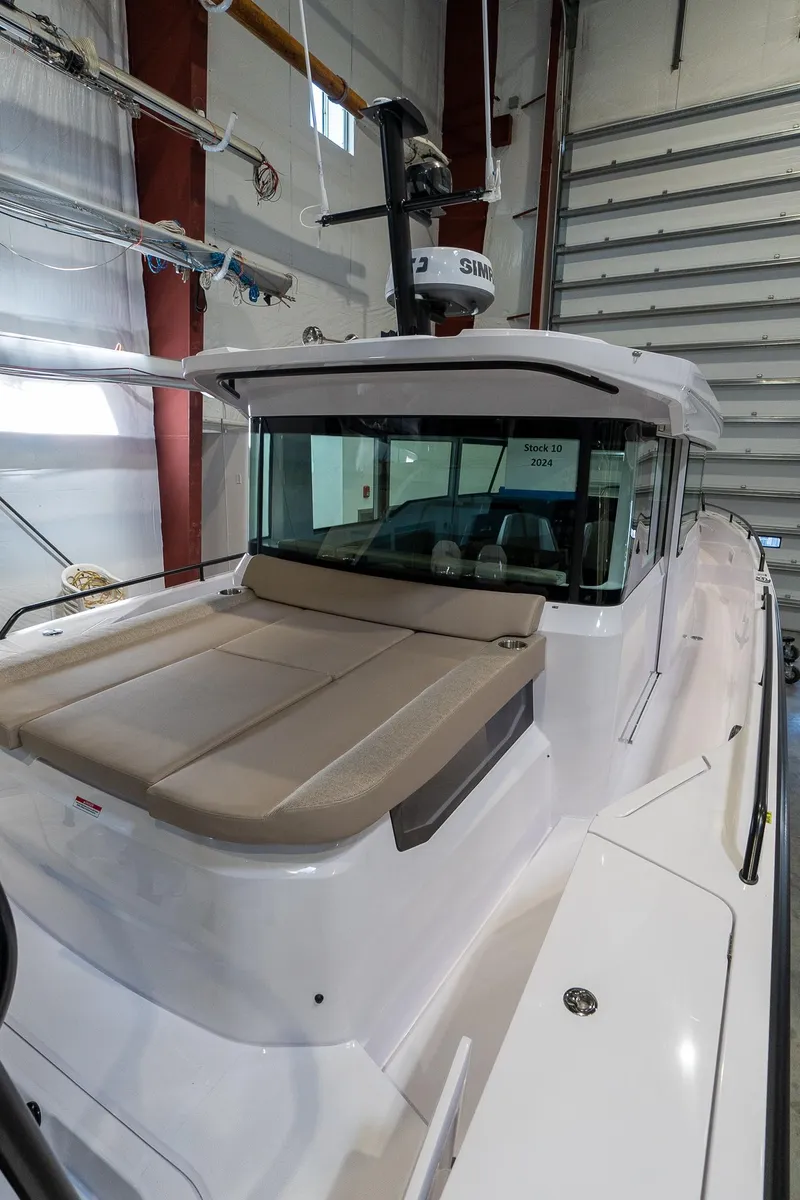 Slide: The Image of 2024 Axopar 37 Cross Cabin XC in a showroom, front view. - 5