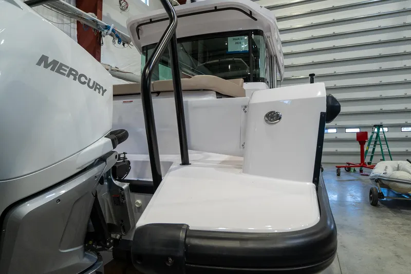 Slide: The Image of 2024 Axopar 37 Cross Cabin XC with Mercury engine in a storage facility. - 6