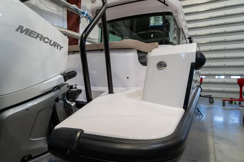 Slide: The Image of 2024 Axopar 37 Cross Cabin XC with Mercury engine in a garage. - 7