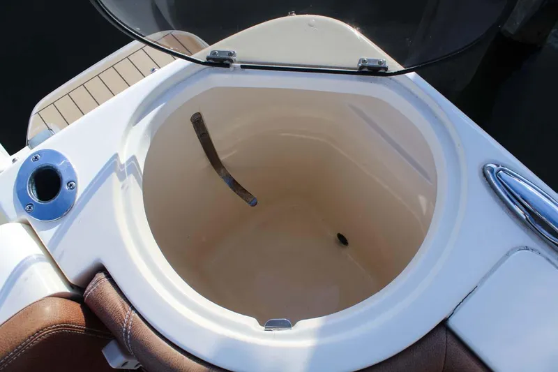 Slide: The Image of 2018 Scout 275 Dorado boat storage compartment with open lid. - 10