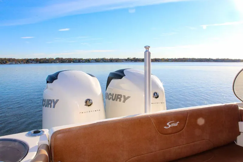 Slide: The Image of 2018 Scout 275 Dorado boat with twin Mercury engines on a calm lake. - 11