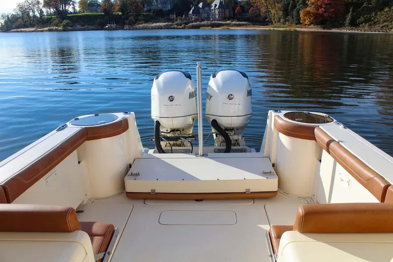 Slide: The Image of 2018 Scout 275 Dorado boat with twin outboard engines on a calm lake. - 12