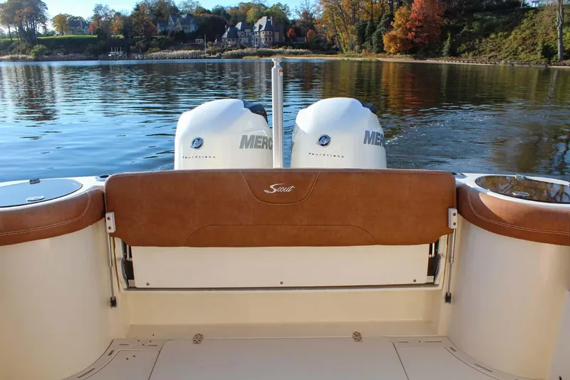 Slide: The Image of 2018 Scout 275 Dorado boat with twin Mercury engines on a calm lake. - 13