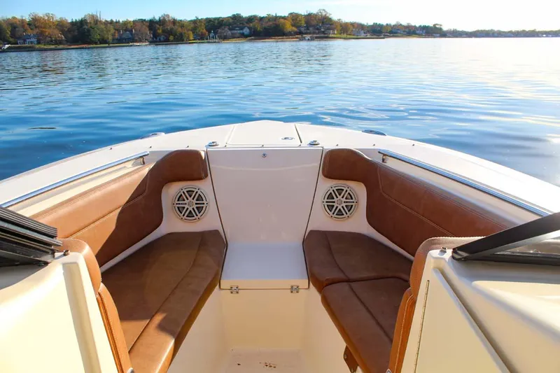 Slide: The Image of 2018 Scout 275 Dorado boat interior with brown seating on calm water. - 15