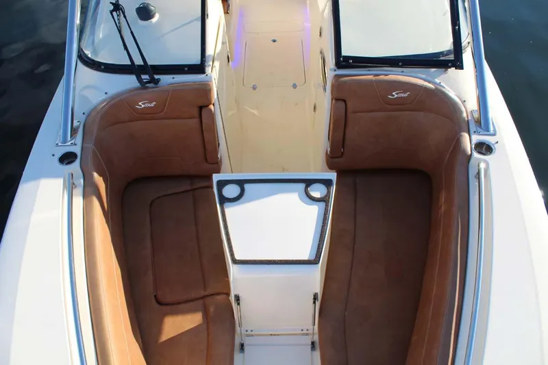 Slide: The Image of 2018 Scout 275 Dorado boat interior with tan seating and white accents. - 17