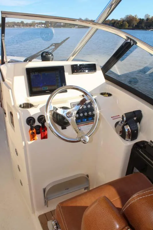 Slide: The Image of 2018 Scout 275 Dorado boat helm with steering wheel and navigation system. - 21