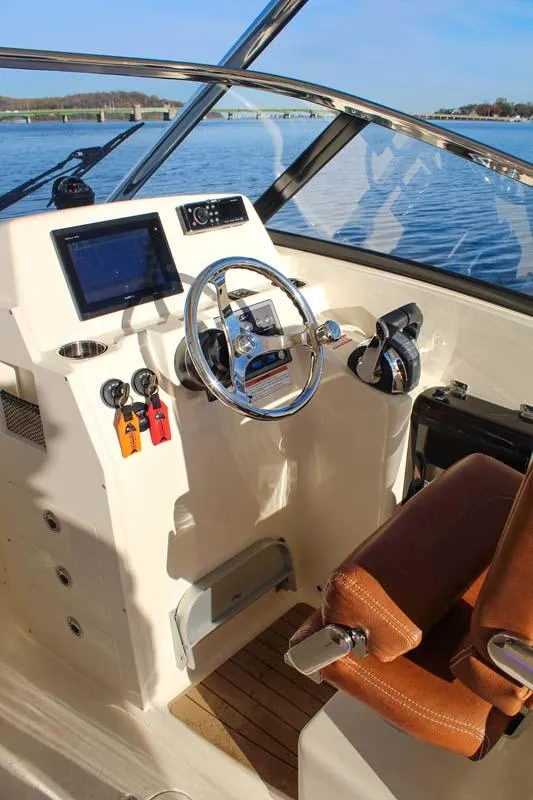 Slide: The Image of 2018 Scout 275 Dorado boat helm with modern controls and leather seat. - 24