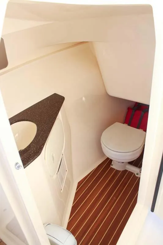 Slide: The Image of 2018 Scout 275 Dorado boat interior with toilet and sink. - 4