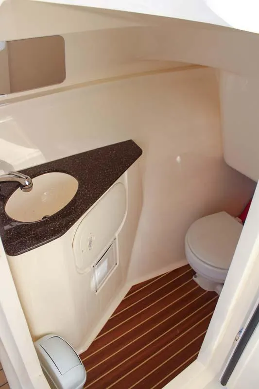 Slide: The Image of 2018 Scout 275 Dorado boat interior bathroom with sink and toilet. - 5