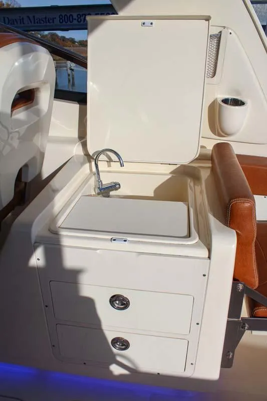 Slide: The Image of 2018 Scout 275 Dorado boat interior with sink and storage drawers. - 9