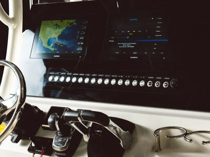 Slide: The Image of 2024 Key West 263 FS boat dashboard with Garmin navigation screens and controls. - 8