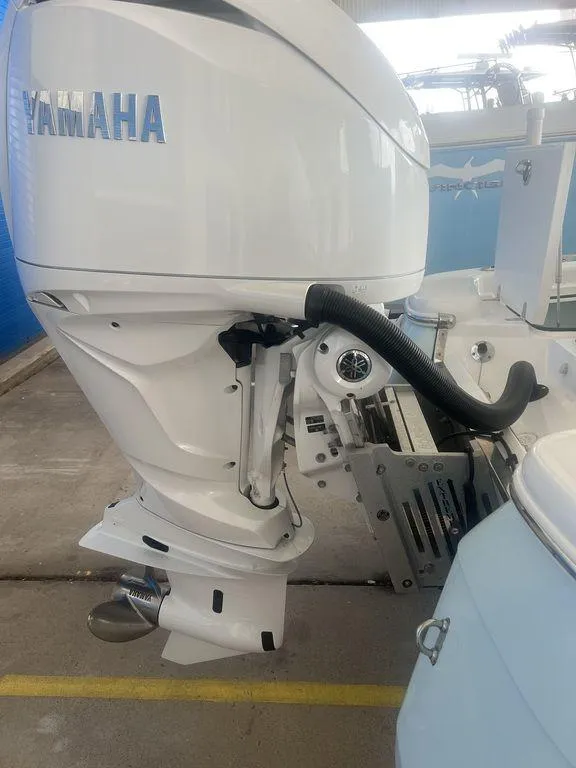 Slide: The Image of 2024 BlackJack 256 Bay boat with Yamaha outboard motor in a showroom. - 11