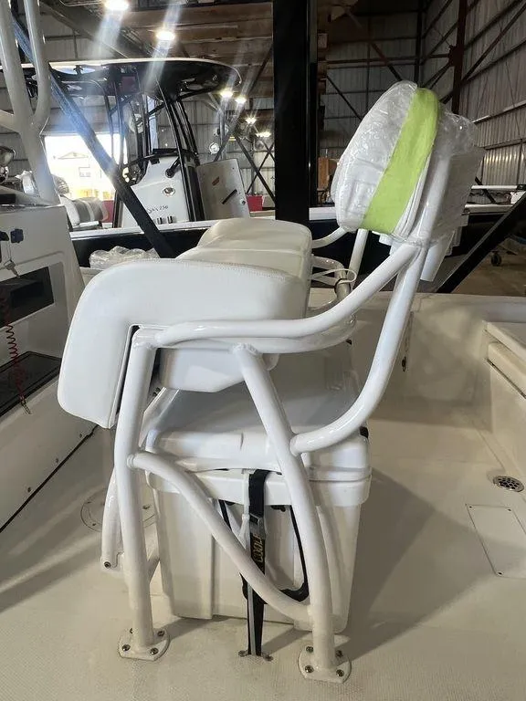 Slide: The Image of 2024 BlackJack 256 Bay boat seat with white cushion in a showroom. - 15