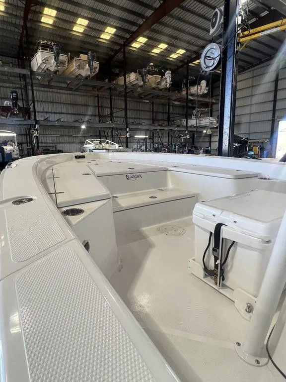 Slide: The Image of 2024 BlackJack 256 Bay boat interior in a storage facility. - 16