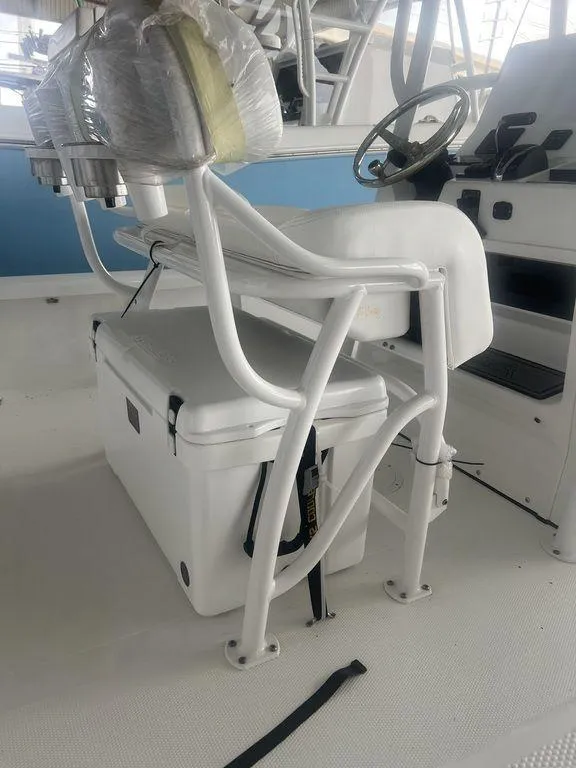 Slide: The Image of 2024 BlackJack 256 Bay boat interior with white seating and steering console. - 17