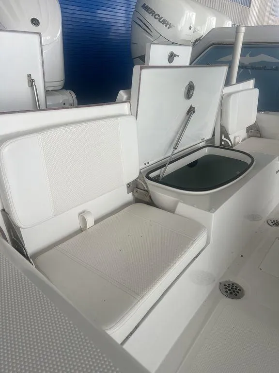 Slide: The Image of 2024 BlackJack 256 Bay boat interior with seating and storage compartments. - 18