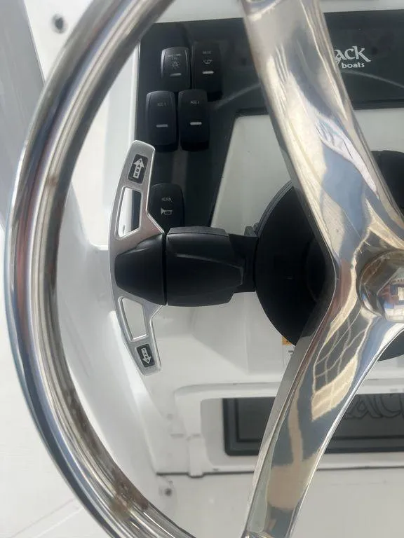 Slide: The Image of Close-up of 2024 BlackJack 256 Bay boat steering wheel and controls. - 23