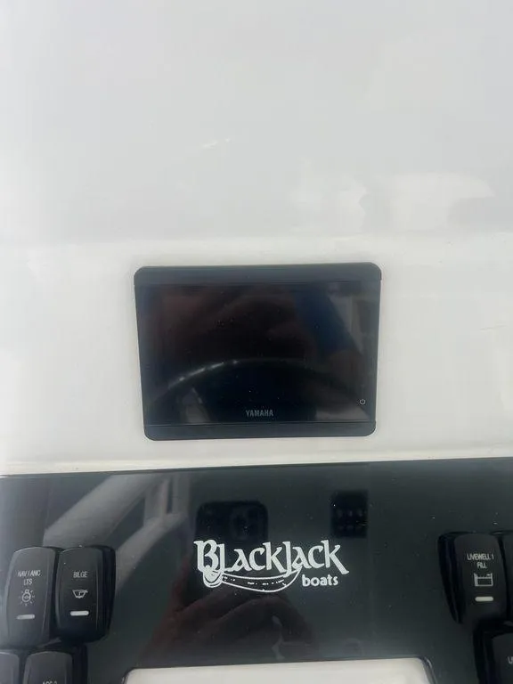 Slide: The Image of 2024 BlackJack 256 Bay boat dashboard with Yamaha display and controls. - 24