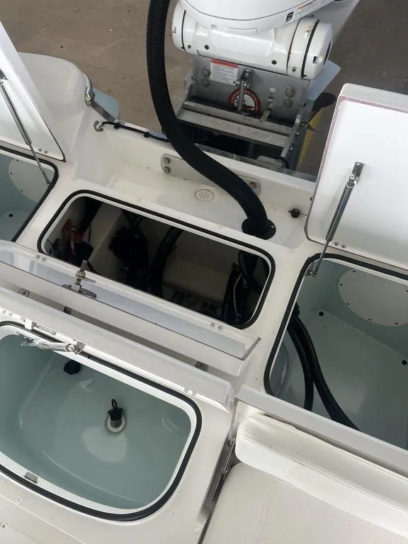 Slide: The Image of 2024 BlackJack 256 Bay boat interior with open storage compartments. - 30