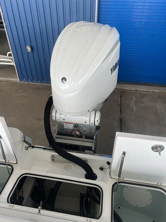 Slide: The Image of 2024 BlackJack 256 Bay boat with Yamaha outboard motor in a garage. - 32