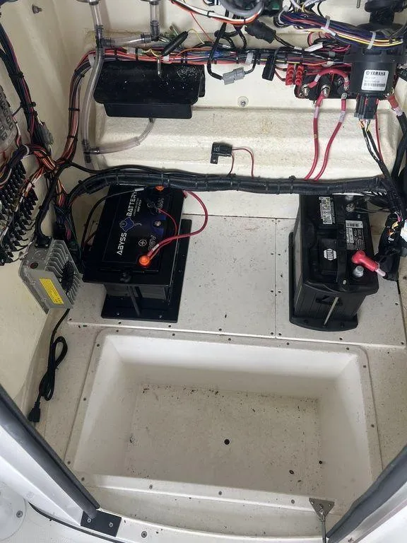Slide: The Image of 2024 BlackJack 256 Bay boat battery compartment with wiring and components. - 33