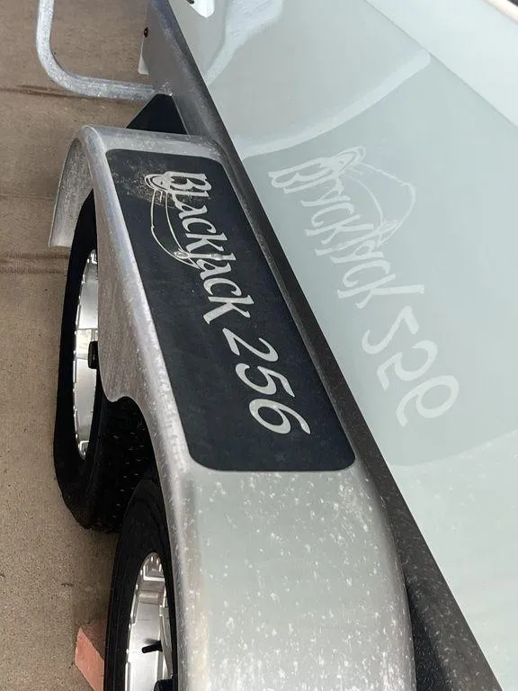 Slide: The Image of 2024 BlackJack 256 Bay boat trailer with logo reflection. - 34