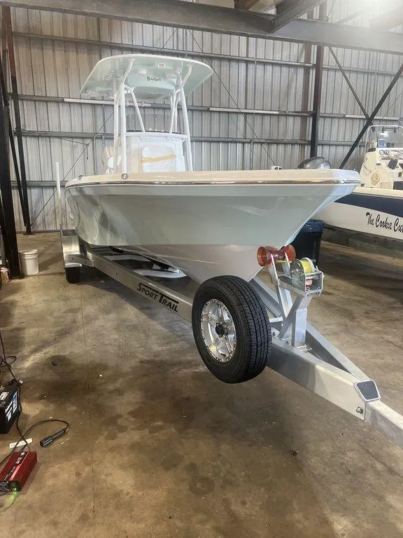 Slide: The Image of 2024 BlackJack 256 Bay boat on trailer in warehouse setting. - 5