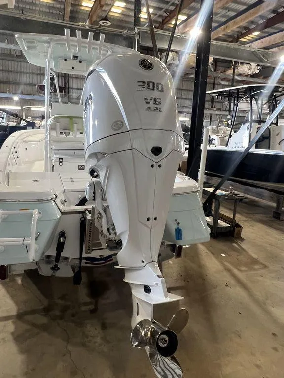 Slide: The Image of 2024 BlackJack 256 Bay boat with powerful 300 HP outboard motor in showroom. - 6