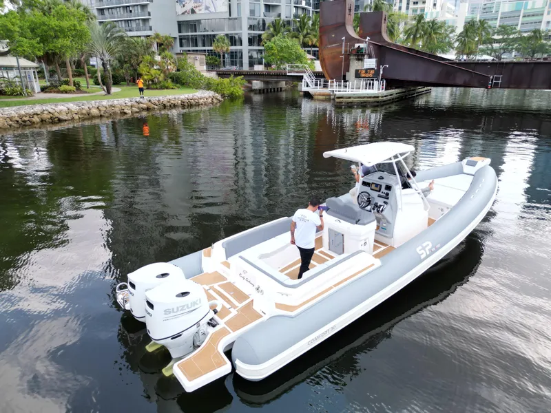 Slide: The Image of 2024 Sea Prop COMFORT 30 boat on calm water with dual Suzuki engines. - 4