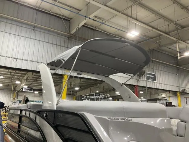 Slide: The Image of 2023 Bennington 25 RFBWA Quad Bench Tritoon in a factory setting. - 7