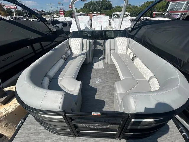 Slide: The Image of 2023 Bennington 25 RFBWA Tritoon interior with gray and white quad bench seating. - 9