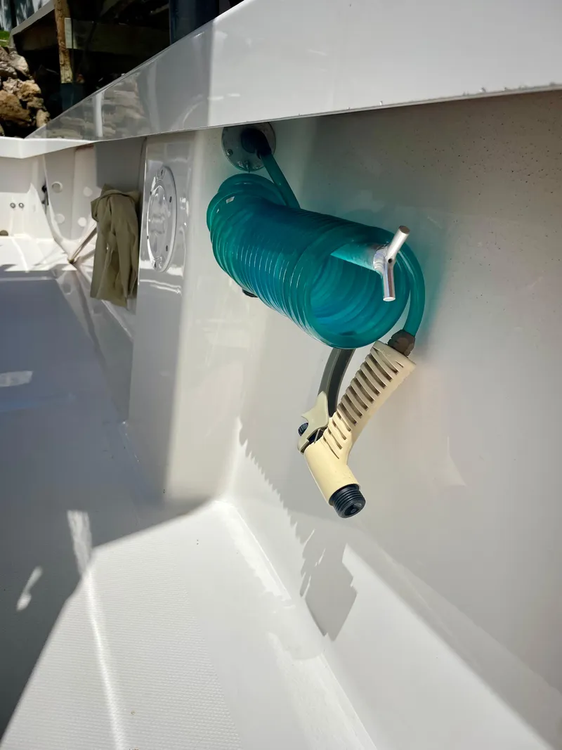Slide: The Image of Coiled hose on a 2019 Rambo 27 boat deck. - 10