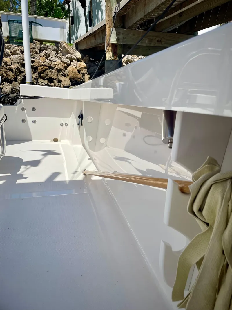 Slide: The Image of 2019 Rambo 27 boat interior with white finish and storage compartments. - 11