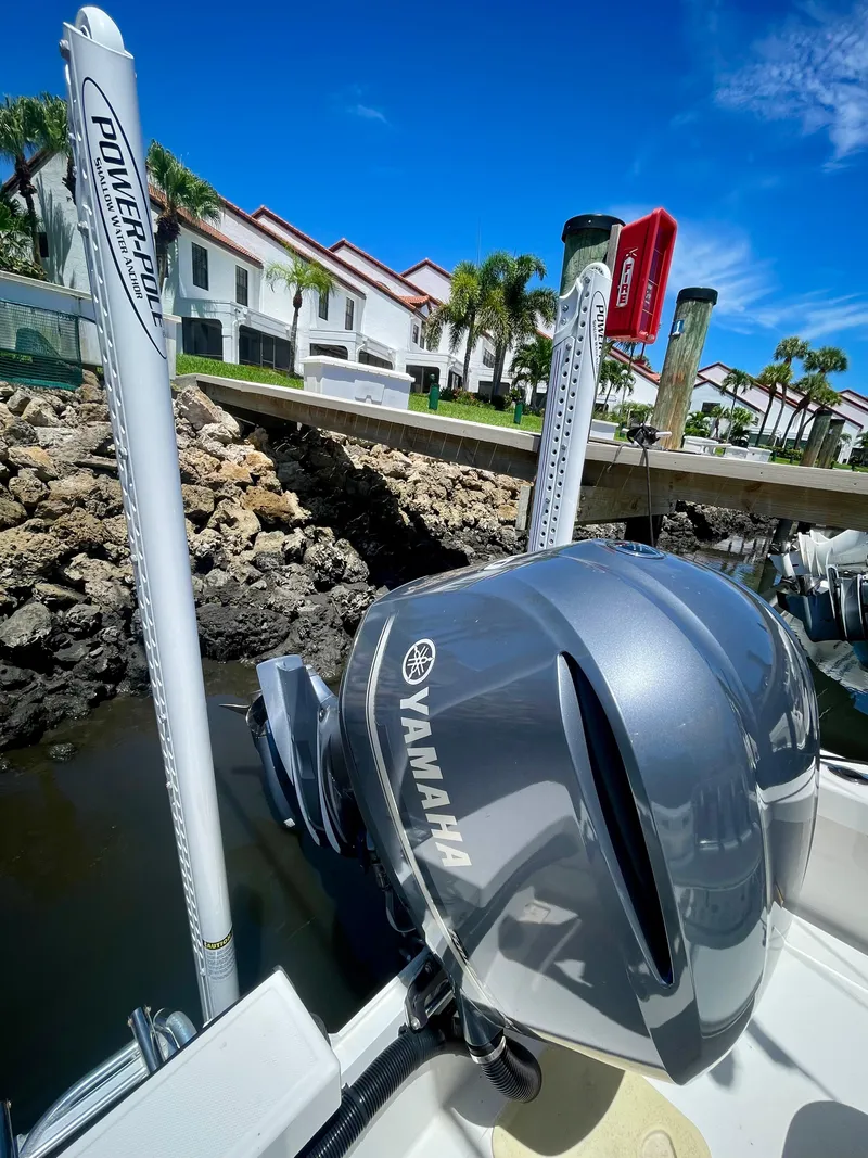Slide: The Image of Rambo 27 boat (2019) with Yamaha outboard motor docked near waterfront homes. - 12