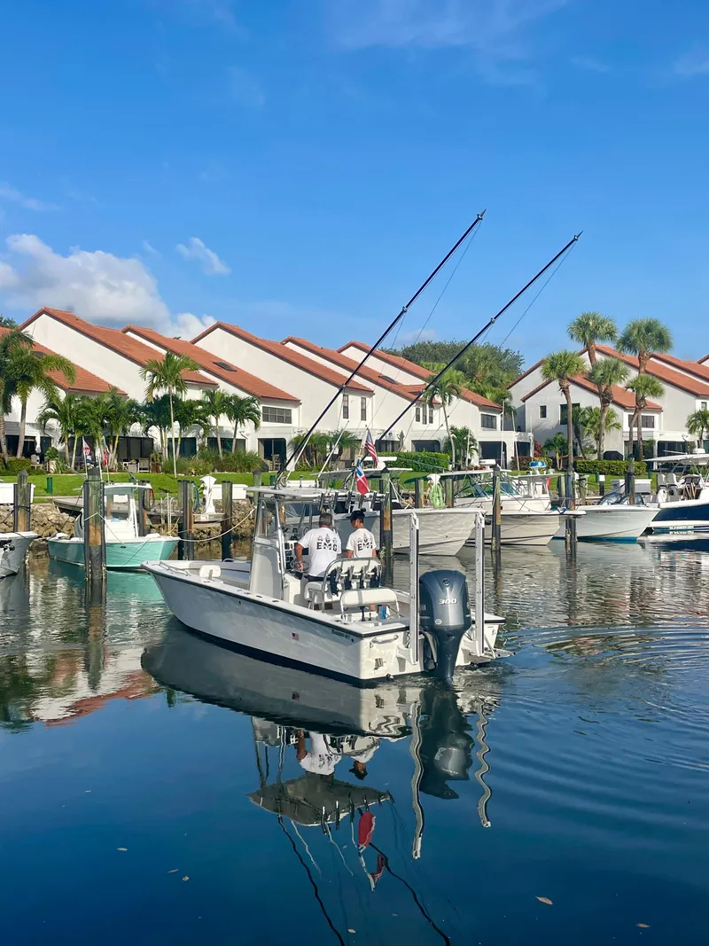 Slide: The Image of Fishing boat Rambo 27 (2019) docked in a marina with waterfront homes. - 17