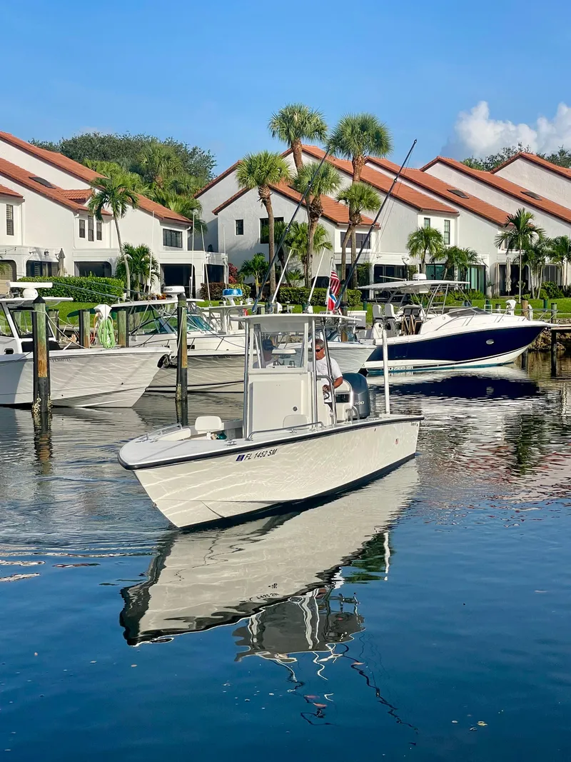 Slide: The Image of 2019 Rambo 27 boat docked near waterfront homes. - 19