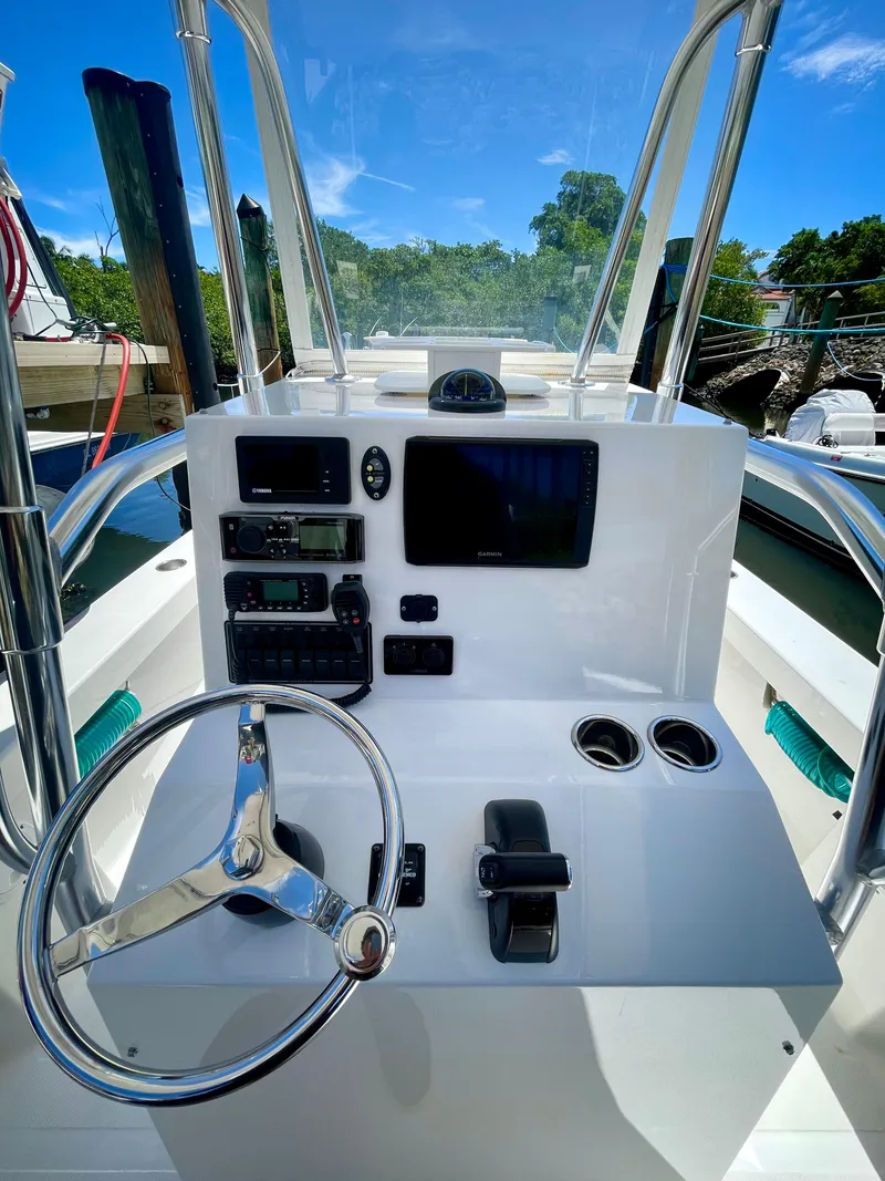Slide: The Image of 2019 Rambo 27 boat console with steering wheel, controls, and navigation equipment. - 2