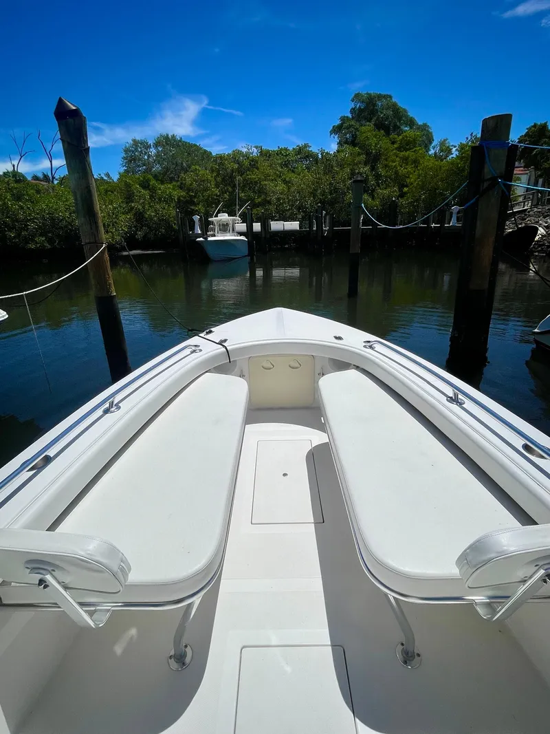 Slide: The Image of 2019 Rambo 27 boat docked in a serene marina. - 5