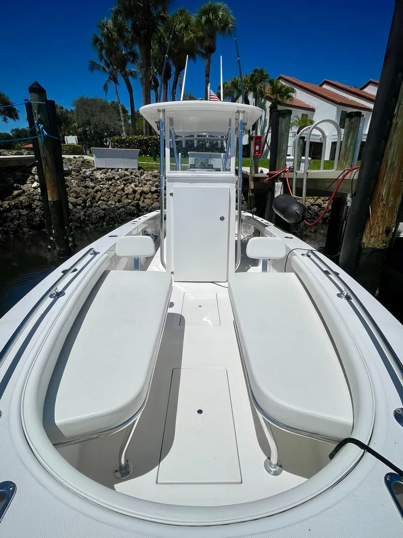 Slide: The Image of 2019 Rambo 27 boat docked, featuring spacious seating and modern design. - 6