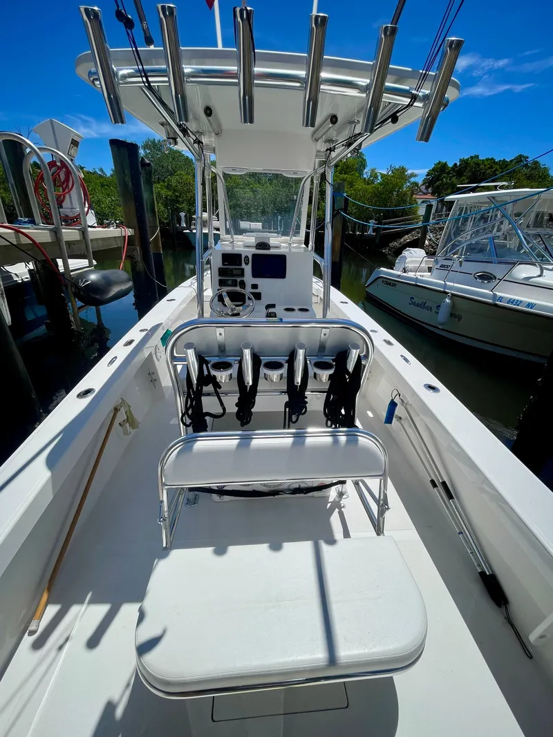 Slide: The Image of 2019 Rambo 27 boat with fishing rod holders docked at marina. - 8